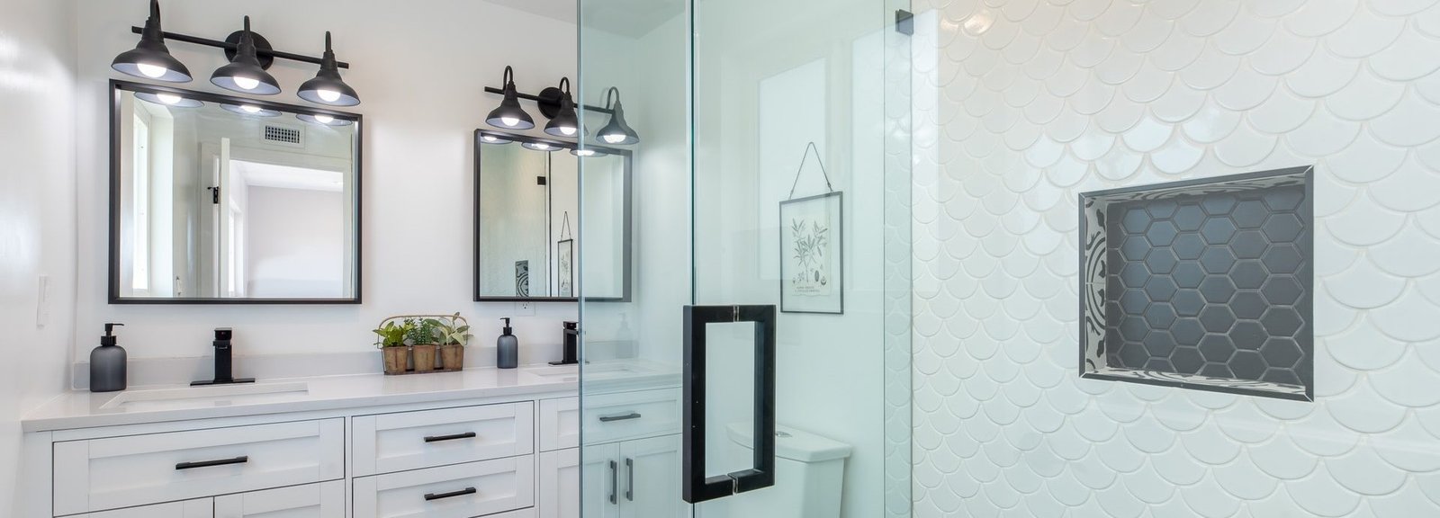 Elegant bathroom design with a Frameless Shower and Trendy Geometric Tile Backsplash