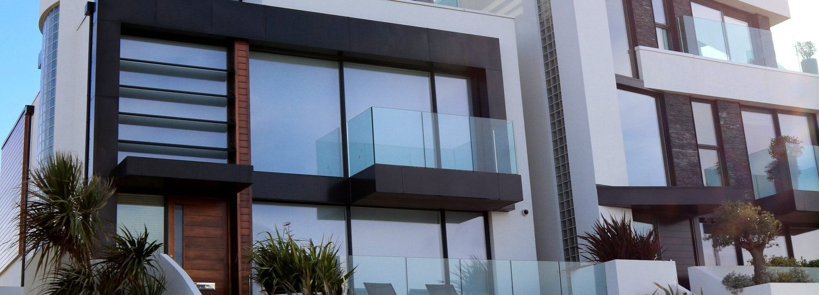 Modern mansion with frameless glass exterior design