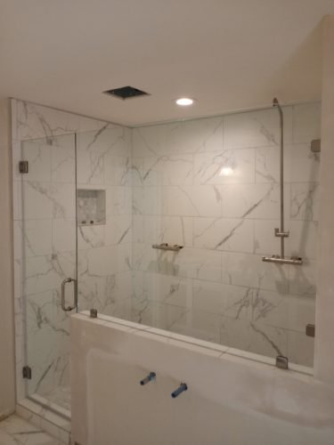 Frameless Shower with Pony Wall Glass Panel and Hinged Door, Marble Tile — Houston TX